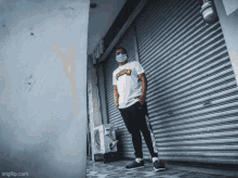 a man wearing a thrasher shirt stands in front of a store