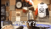 a man is standing in front of a jersey that says fifty ?
