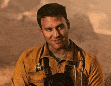 a man wearing a yellow jacket with a stethoscope around his neck .
