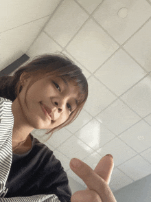 a girl giving the peace sign with her fingers