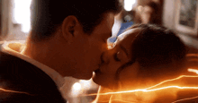 a man and a woman are kissing in front of a lightning bolt .