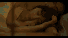 a woman is sitting in a bathtub with two candles in front of her .
