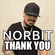 a man is wearing a hat and a necklace and says norbit thank you .