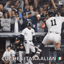 a baseball player with the number 11 on his jersey swings his bat
