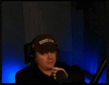 a man wearing a brown hat that says home run on it