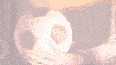a person holding a soccer ball in their hands