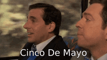two men sitting next to each other with the words cinco de mayo written below them