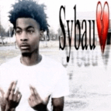 a man in a white shirt is giving the middle finger in front of a sybau logo