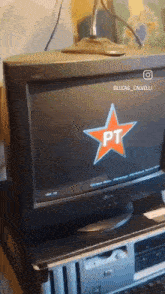 a computer monitor with a red star and the letter pt on it