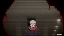 a man with a scar on his face is standing in a dark room with blood coming out of a hole in the wall .