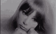 it is a black and white photo of a woman with long hair .