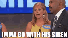 a man in a suit and tie stands next to a woman with a name tag that says brooke on it .