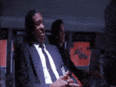 a man in a suit and tie with a name tag that says ' a. j. ' on it