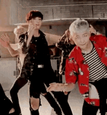 a group of men are dancing together in a room .