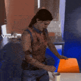 a woman is standing in a kitchen with a viggle.ai watermark