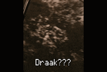 a man with a mustache is sitting in a car and the word draak is written on his face