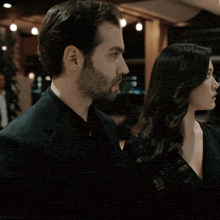 a man and a woman standing next to each other