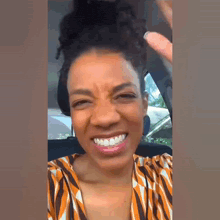 a woman in a striped shirt is smiling and making a face