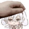 a hand is holding a cartoon character 's head and holding a book .