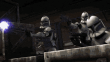 a group of storm trooper soldiers are shooting a laser beam at each other .