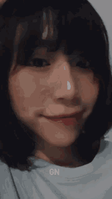 a close up of a woman 's face with the word gn written on the bottom .