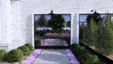 a white brick building with a black door and purple flowers