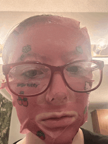 a woman with a hello kitty tattoo on her face