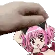 a hand is holding a pink anime girl with cat ears .