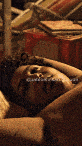 a man with curly hair is laying down with his eyes closed and the words @pabloeluisao.facclube below him
