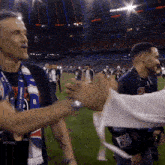 a man wearing a scarf that says ' champions league ' on it