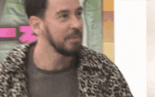 a man with a beard and a leopard print jacket