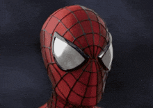 a close up of a spider man helmet with a spider web pattern