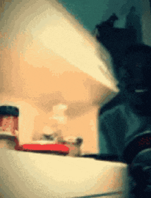 a jar of jam sits on a counter in a blurry image