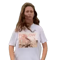 a woman wearing a white t-shirt that says " follow me back "