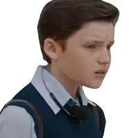 a young boy wearing a vest and headphones has a serious look on his face