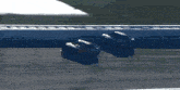 two race cars are racing on a track and one has the number 14 on the front