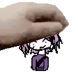 a hand is holding a small cartoon character with purple hair .