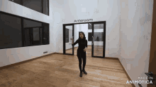 a woman stands in an empty room with a sign that says anteroom