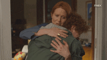 a woman hugging a man with the word max on the bottom right