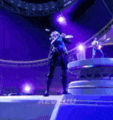 a man is playing a guitar while a woman sings on a stage in a video game .