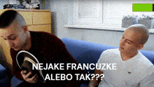 two men are sitting on a blue couch with the words nejake francuzke alebo tak written above them