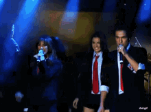 a group of people singing on a stage with a watermark that says rbd.gif at the bottom