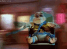 a stuffed animal is sitting in a chair with the name peteneems on the bottom right