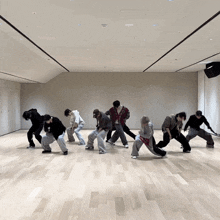 a group of people are dancing in a room