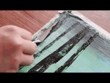 a person is painting a picture of a forest