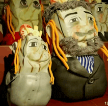 a bunch of stuffed heads with the number 12 on the bottom right