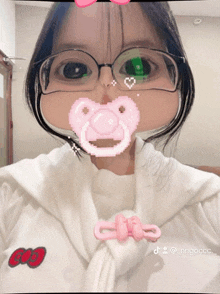 a girl wearing glasses and a pacifier in her mouth