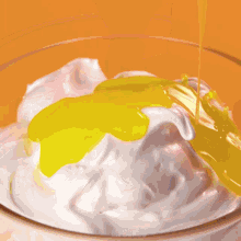 a bowl of whipped cream with a spatula and the word mr.cakes on the bottom right