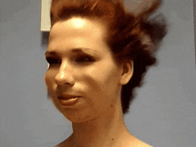 a woman with red hair is making a funny face