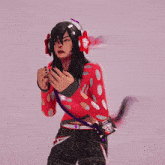 a girl wearing headphones and a red sweater with white dots